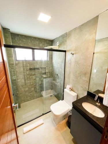 a bathroom with a shower and a toilet and a sink at Fontes da Pipa by Liiv in Pipa