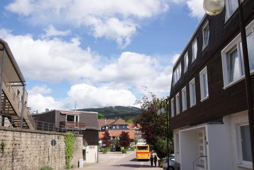 a street with buildings and a yellow van parked on the street at Hotel Braunlage in Braunlage