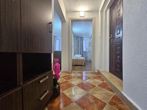 a hallway with a living room with a television and a room with a bedroom at Athos Guesthouse in Kotor