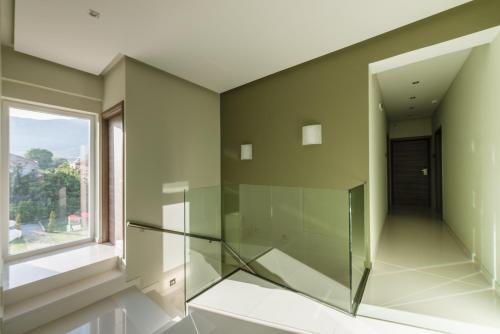 a glass elevator in a room with a window at Lagaria Luxury Rooms & Apartments in Asprovalta