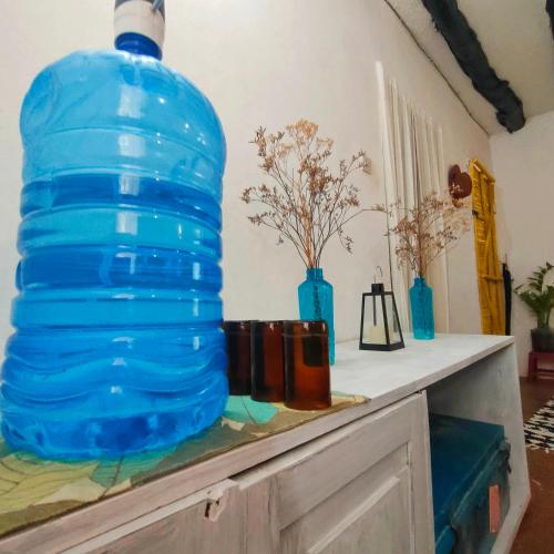 a large blue water bottle sitting on top of a table at Palm Sunrise in Diani Beach