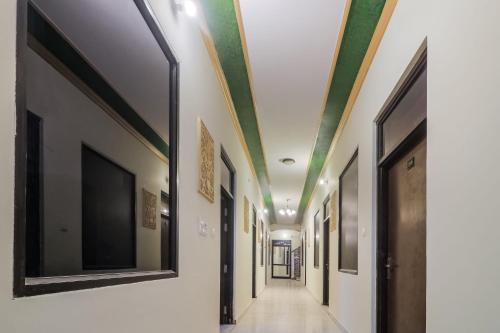 a corridor with green ceilings in a hallway at Hotel O Hill View in Jairāmpura