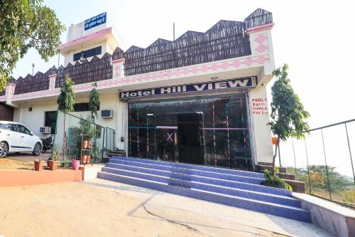 a hotel full view with stairs in front of it at Hotel O Hill View in Jairāmpura