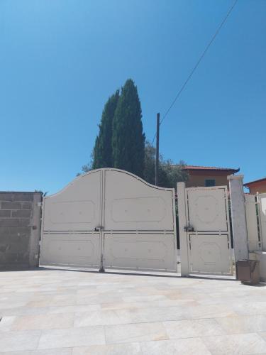 a pair of white garage gates in a driveway at Villa Ornella in Luni