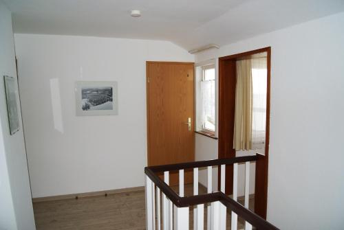 a stairway with a wooden door and a window at Hotel Braunlage in Braunlage