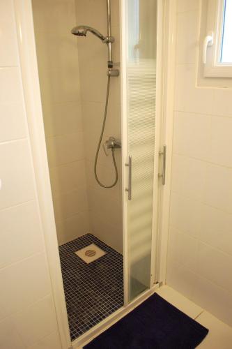 a shower with a glass door in a bathroom at Le Pénity, studio lumineux à Carnoët in Carnoët