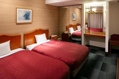 Postel nebo postele na pokoji v ubytování Narita Gateway Hotel