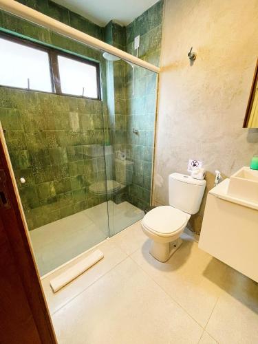 a bathroom with a toilet and a glass shower at Fontes da Pipa by Liiv in Pipa