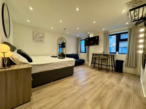 a bedroom with a bed and a living room at Canal Walk Studio Apartments in Southampton