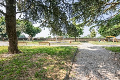 a park with benches and a tree and a playground at Arno Breeze – Casa Manin in Calcinaia