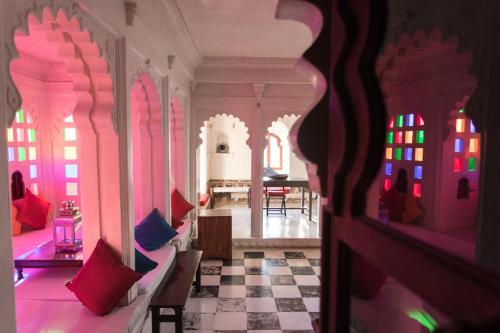 a room with pink walls and a checkerboard floor at Madri Haveli in Udaipur