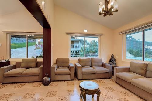 a living room with two couches and a table at Avadale Kodaikanal - Stag Groups Not Allowed in Kodaikānāl