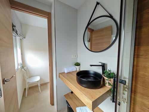 a bathroom with a sink and a mirror on a counter at Hostal Casa Miguel Marbella in Marbella