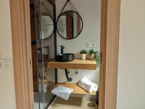 a bathroom with a sink and a mirror at Hostal Casa Miguel Marbella in Marbella