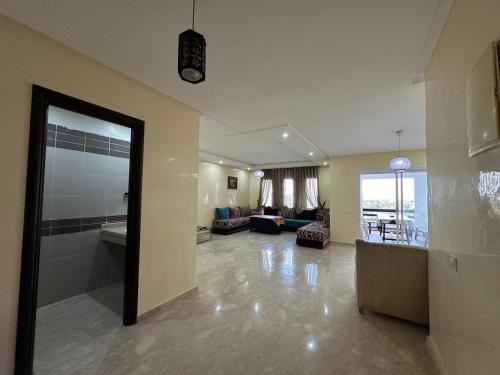 a large room with a living room and a living room at Beach flat with pool at Al Mansouria in O Ben Slimane
