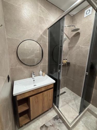 a bathroom with a sink and a shower at VIP кв 10 мкр in Oral