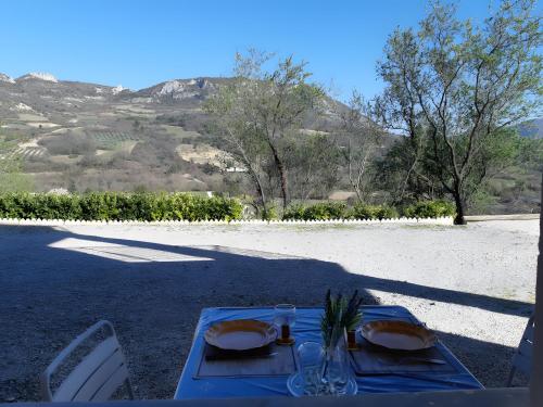 a blue table with two plates of food on it at Gite Du Bas - Le Petit Tilleul in Condorcet