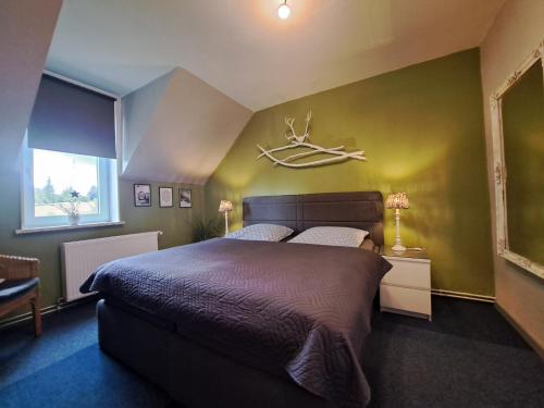 a bedroom with a bed with a antler on the wall at Holl & Boll in Clausthal-Zellerfeld