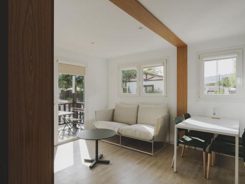 a living room with a couch and a table at wecamp Jávea in Jávea
