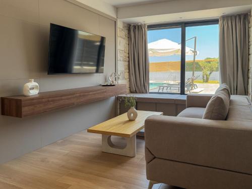 a living room with a couch and a table at The Olive Path in Kalandra