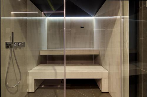 a shower with a glass door in a bathroom at WANDERLUST HOTEL - SUITE & SPA - APARTMENTS & VILLAS - Bardolino, Lago di Garda - Verona in Bardolino