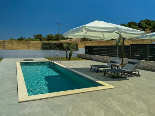 a swimming pool with two chairs and an umbrella at The Olive Path in Kalandra