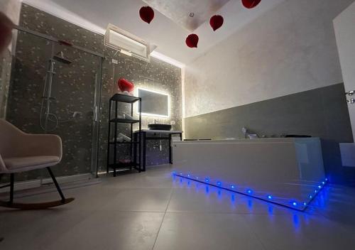 a bathroom with a shower with red hearts on the wall at Il Deseo Suite con vasca idromassaggio in Monteparano