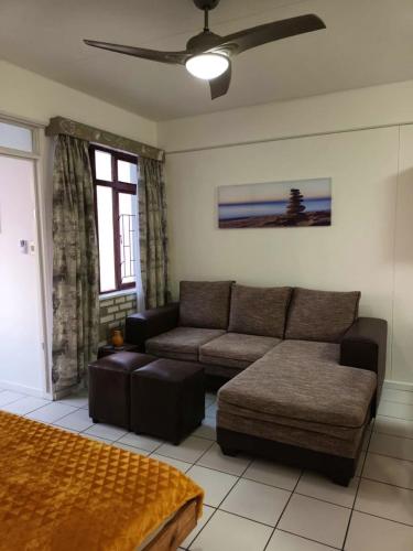 a living room with a couch and a table at South Coast Riviera 203 in Port Shepstone