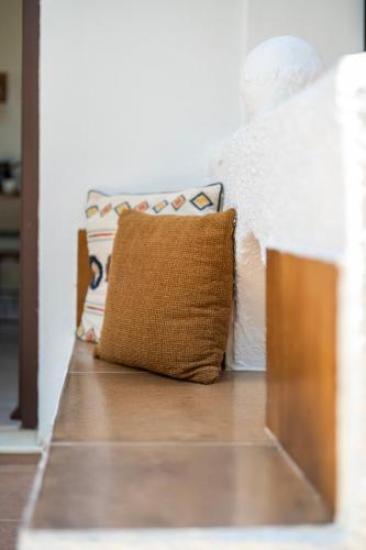 a pillow sitting on top of a wooden floor at SKYROS AVRA Residences in Skiros