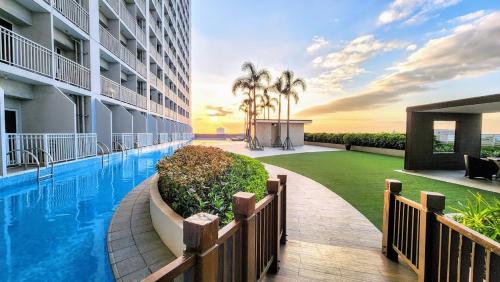 a view of a building with a swimming pool at Chateau Staycation in Manila