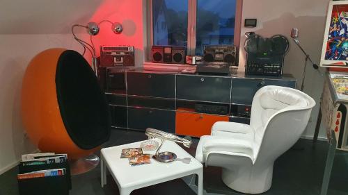 a living room with a chair and a table at Dachgeschoss Designer-Loft Arlberg - Montafon in Bludenz