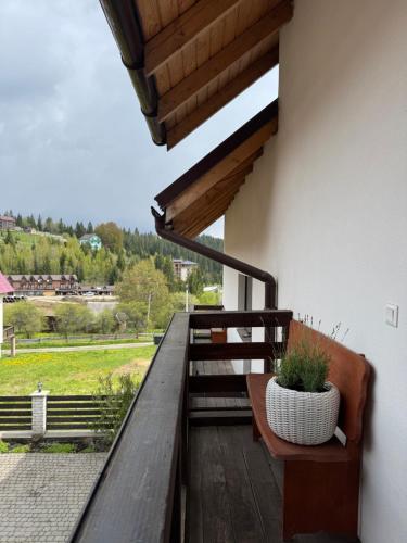 a balcony with a bench and a view of a field at Готель White House in Yablunytsya