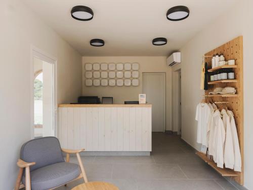 a room with a counter and a chair in it at wecamp Jávea in Jávea