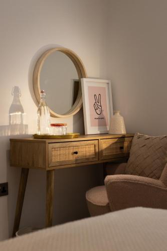 a dressing table with a mirror and a chair at The Wagon Shed in Sowerby Bridge