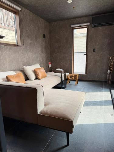 a bedroom with two beds and a bench in it at EKVOLI ROPPONGI TOKYO, Private Hotel in Tokyo