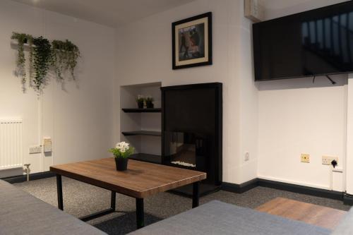 a living room with a coffee table and a fireplace at Bushmills Hostel in Bushmills