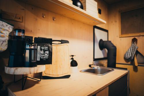 a kitchen counter with a coffee maker and a sink at Posed Rikitan in Spálené Poříčí