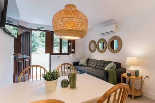 a living room with a table and a couch at Apartamentos Vista Montaña in Cangas de Onís