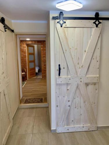 a sliding barn door in a room with a hallway at Mazurski dom Brejdyny Sauna i Bania in Mrągowo