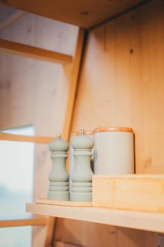 a shelf with two vases and a pot on it at Posed Rikitan in Spálené Poříčí