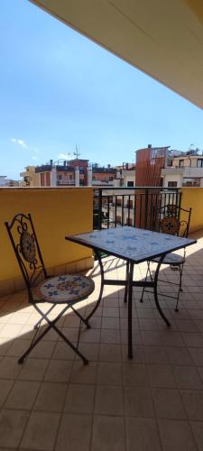 a table and two chairs sitting on a balcony at Julie house in Sabaudia