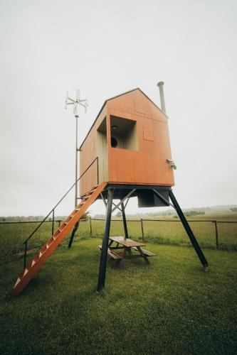 a play house with a staircase in the grass at Posed Rikitan in Spálené Poříčí