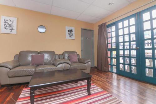a living room with a couch and a coffee table at Hotel Check Inn 2 Cameron Highlands in Brinchang