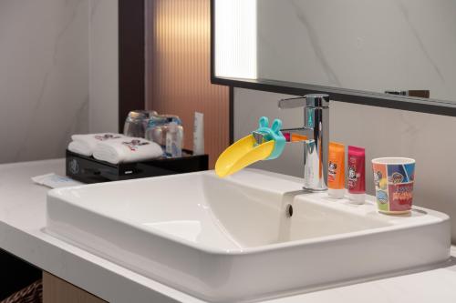 a bathroom sink with a faucet in a bathroom at Hampton by Hilton Guangzhou Baiyun Airport Cultural Tourism City in Guangzhou