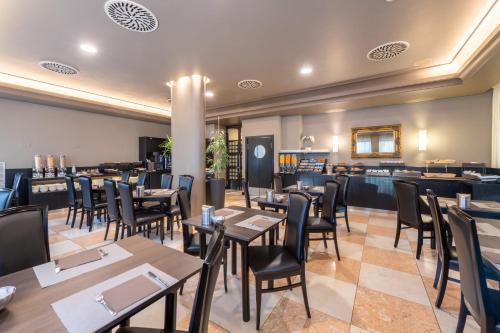 a dining room with wooden tables and chairs at Hotel Palace Verona in Verona