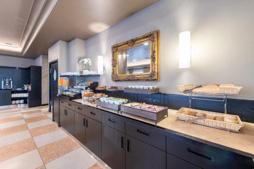 a bakery with a counter with bread and pastries at Hotel Palace Verona in Verona