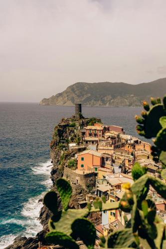 a small town on a rocky island in the ocean at The Vernazza Spot in Vernazza
