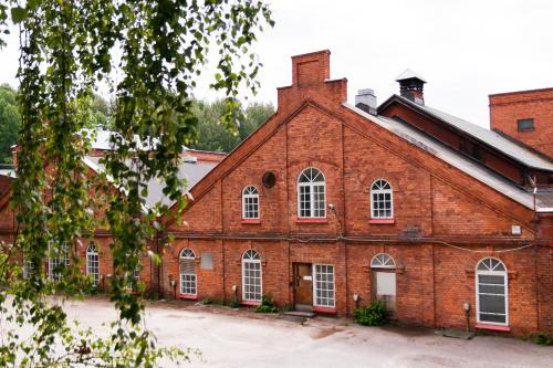 an old red brick building with white windows at Tehdassaari Nokia HQ - Pääkonttori in Nokia