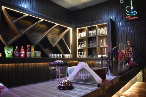 a bar with a table and a shelf of alcohol at Hotel Manish Mansion in Lumbini