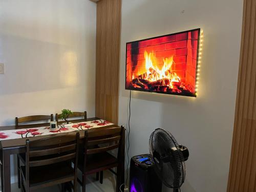 a living room with a fireplace on the wall at Chateau Staycation in Manila